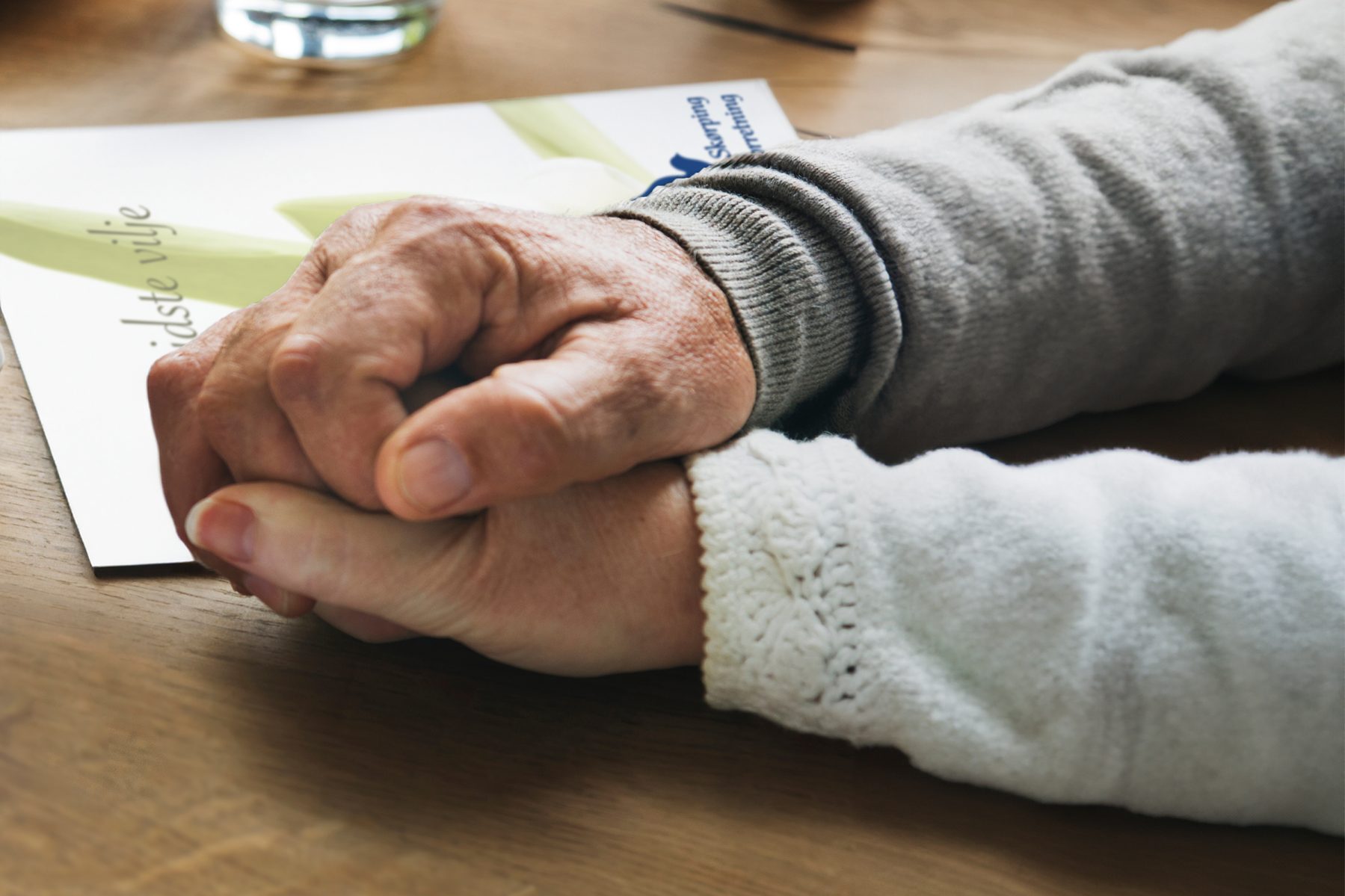 Senior married coupple comforting each other and holding hands
